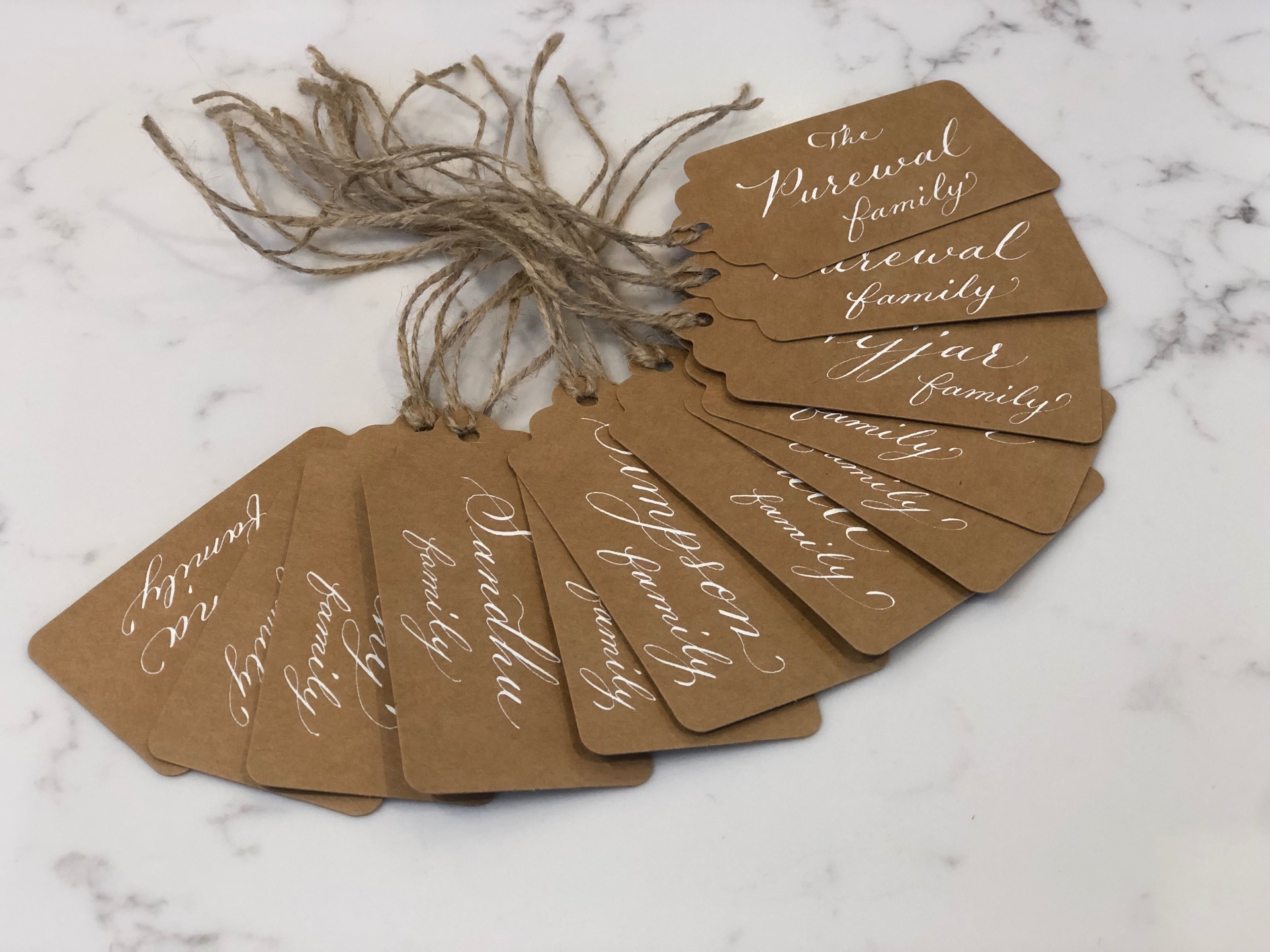 Handwritten kraft gift tags with white calligraphy